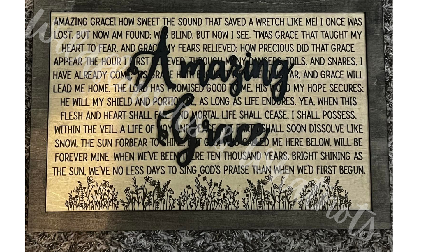 Decorative sign with 'Amazing Grace' wooden text over the lyrics with a floral design on a black wood back. Customizable Size and Color.