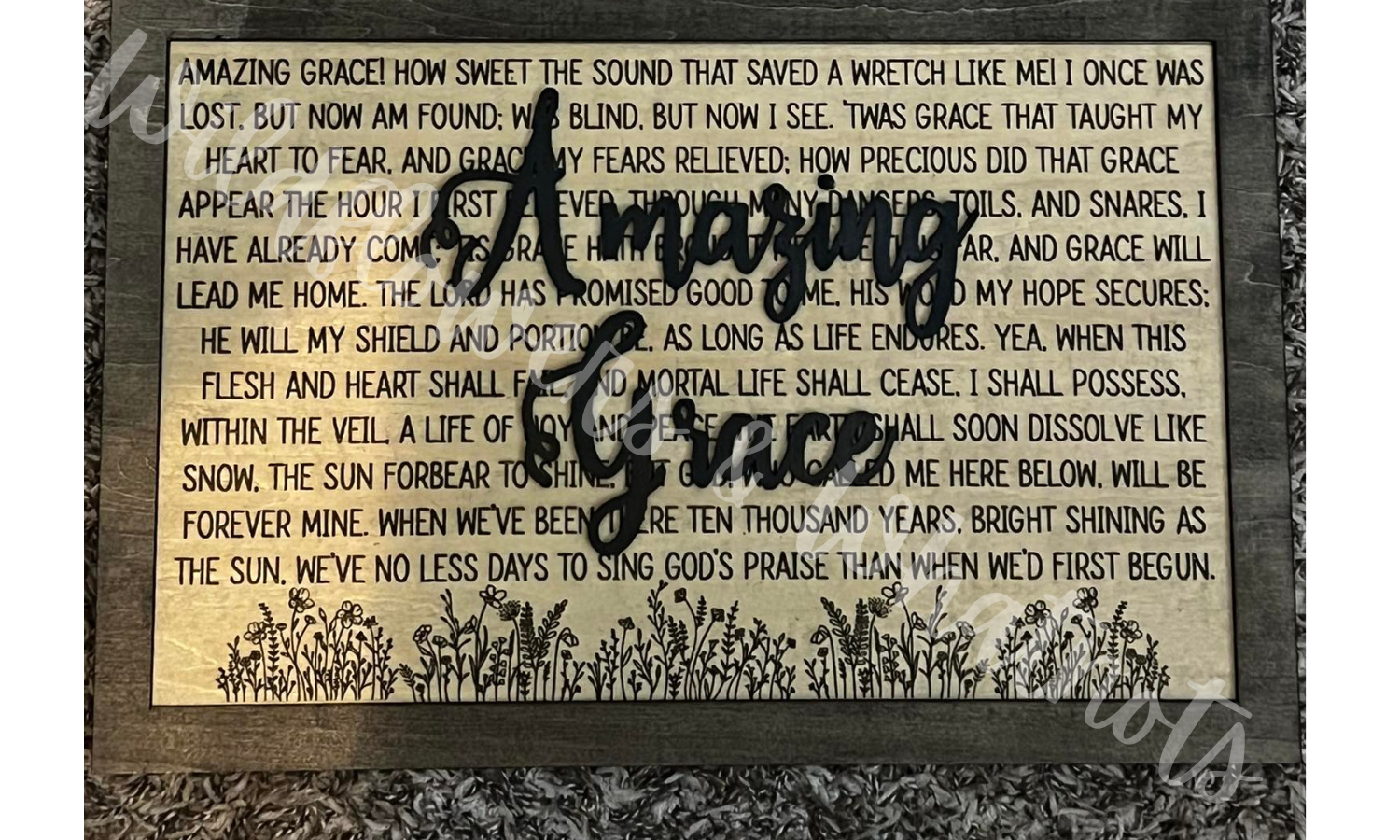 Decorative sign with 'Amazing Grace' wooden text over the lyrics with a floral design on a black wood back. Customizable Size and Color.